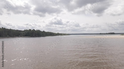 Drone flying over a river delta near sea, birds flying around
