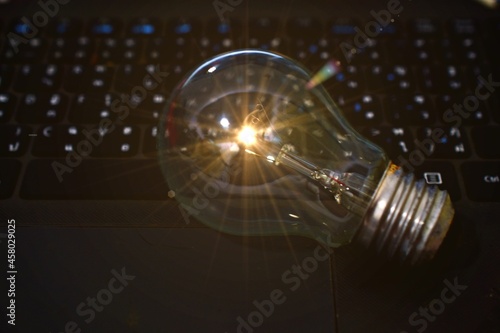 The lamp on the keyboard illuminates the darkness, inspiration and creativity ideas.