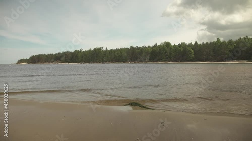 River entering the sea with sandbank in the foreground