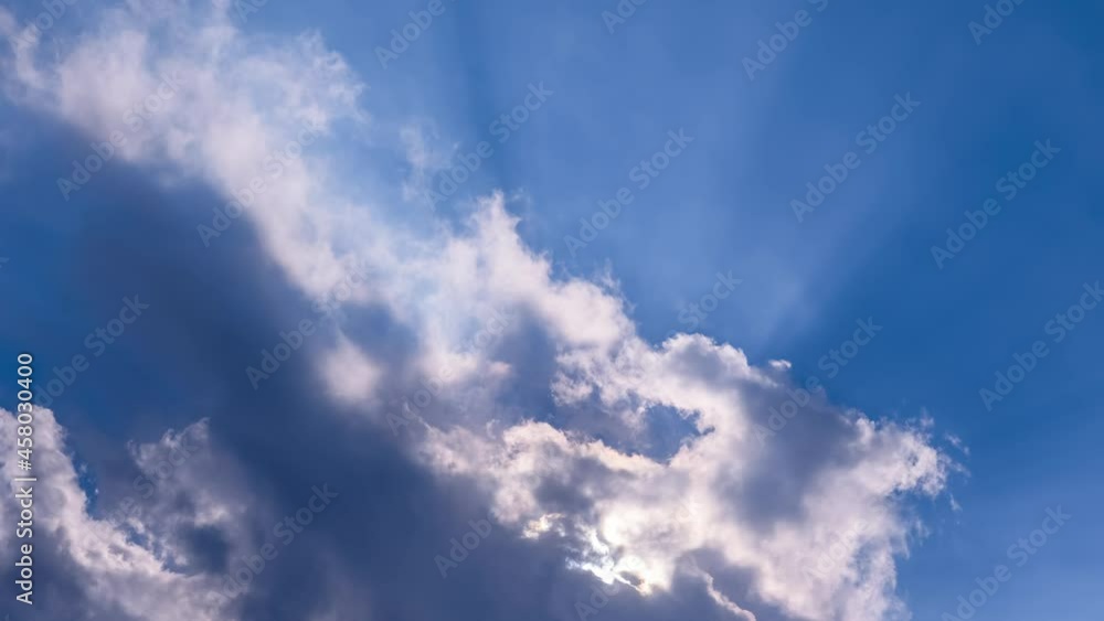 Clouds formation in blue sky with sun rays. Timelapse, fast moving. Clean air, climate change, weather concept Clouds formation in blue sky with sun rays. Timelapse, fast moving. Clean air, climate change, weather concept