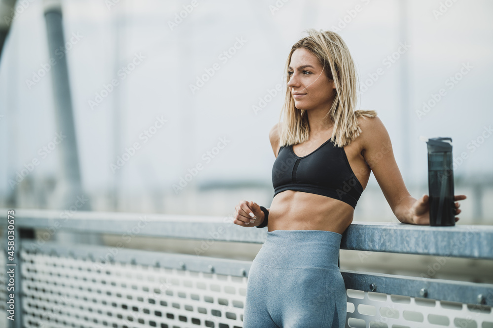 Woman Holding Water Bottle And Resting After Outdoor Working Out Woman Holding Water Bottle And Resting After Outdoor Working Out