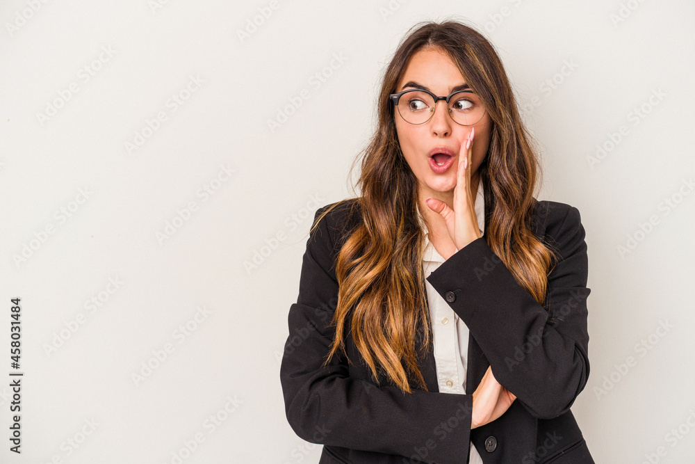 Young caucasian business woman isolated on white background is saying a secret hot braking news and looking aside Young caucasian business woman isolated on white background is saying a secret hot braking news and looking aside