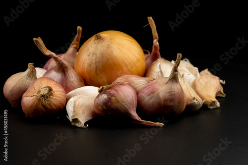 Whole group pile ingredient of fresh onion garlic group isolated on black background