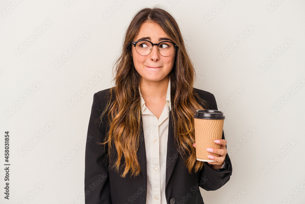 Young caucasian business woman holding a takeaway coffee isolated on white background confused, feels doubtful and unsure. Young caucasian business woman holding a takeaway coffee isolated on white background confused, feels doubtful and unsure.