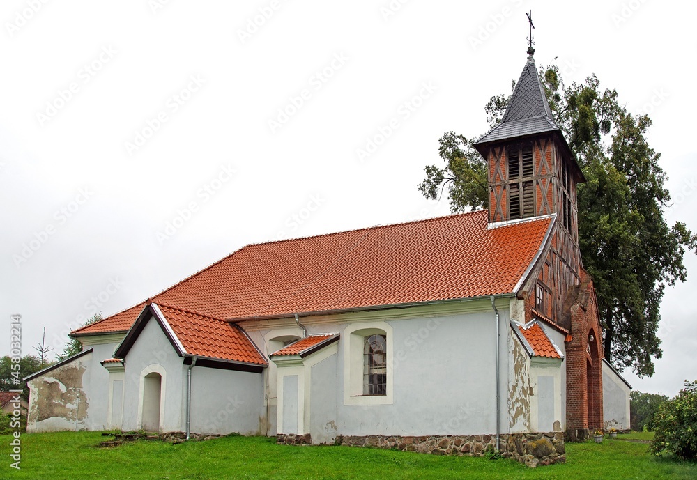 General view and architectural details of the Protestant church built in plastered red brick at the beginning of the 19th century in the village of Rańsk in Masuria, Poland. General view and architectural details of the Protestant church built in plastered red brick at the beginning of the 19th century in the village of Rańsk in Masuria, Poland.