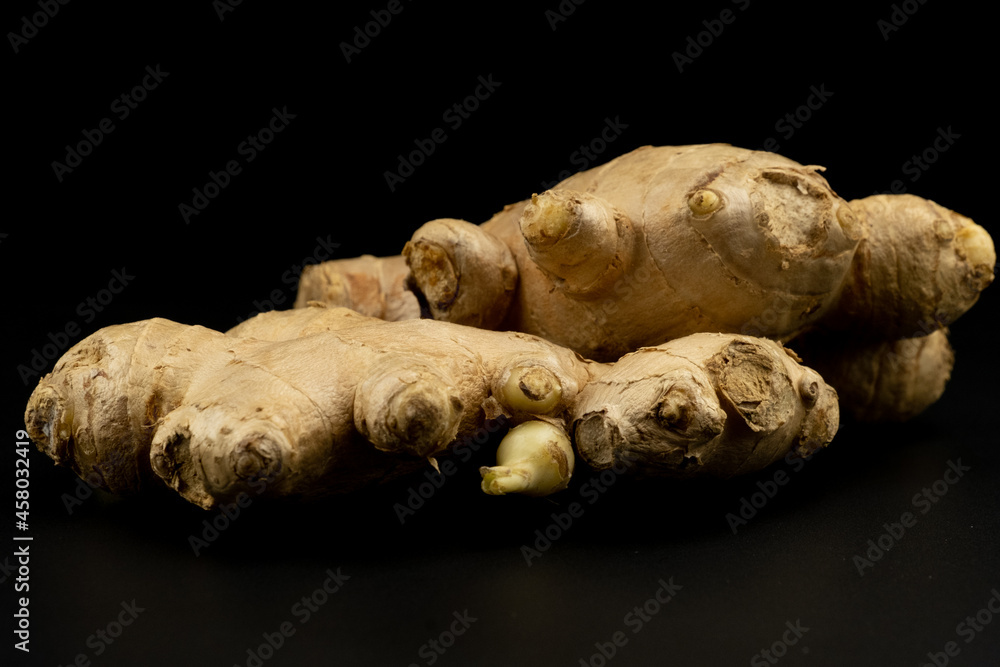 Whole group pile ingredient of fresh ginger group isolated on black background