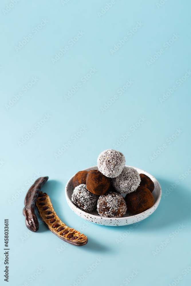 Carob energy balls with nuts, dates and coconut, vegan and vegetarian sweet food Carob energy balls with nuts, dates and coconut, vegan and vegetarian sweet food