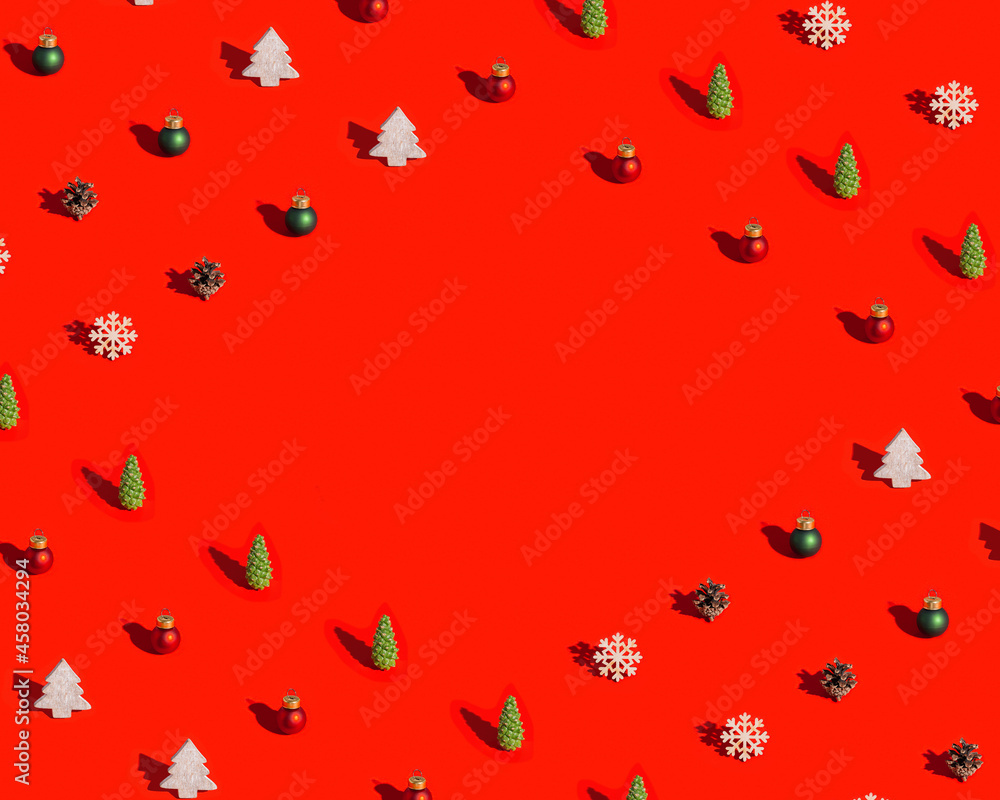 Christmas frame with natural decorations, wooden snowflake and christmas tree, pine cone on red Christmas and New Year Holiday symbols Christmas frame with natural decorations, wooden snowflake and christmas tree, pine cone on red Christmas and New Year Holiday symbols