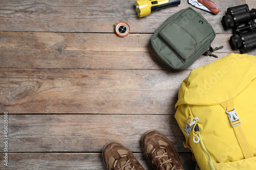 Obraz na płótnie Flat lay composition with tourist backpack and other camping equipment on wooden