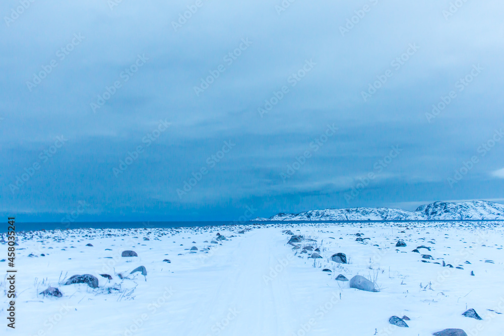 Snow plains on the Barents sea coast beyond the Arctic circle in the far North in the Murmansk region the village of Teriberka in the cold winter Snow plains on the Barents sea coast beyond the Arctic circle in the far North in the Murmansk region the village of Teriberka in the cold winter