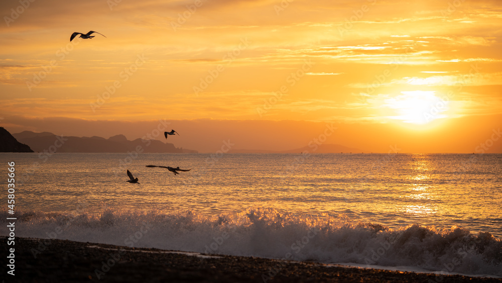 Amazing sunrise over the tropical beach. Yellow sun over sea. Orange colors waves. Nature background. Beautiful serene scene. Morning. Sunlight reflect on water surface Amazing sunrise over the tropical beach. Yellow sun over sea. Orange colors waves. Nature background. Beautiful serene scene. Morning. Sunlight reflect on water surface