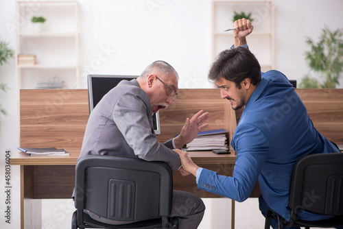Two male employees working in the office © Elnur