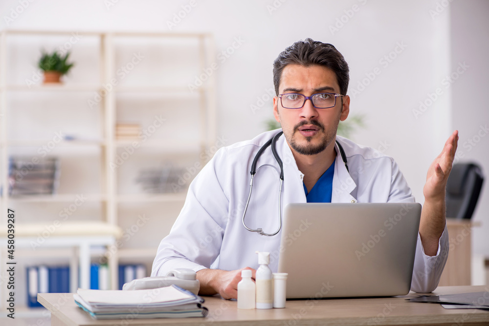 Young male doctor in telemedicine concept Young male doctor in telemedicine concept