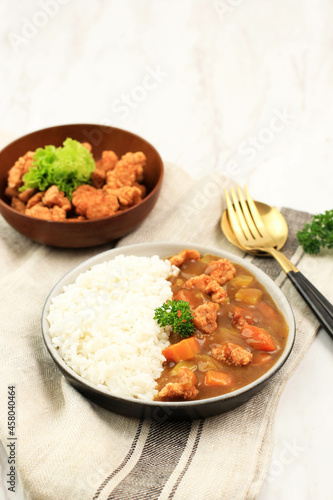 Close Up Chicken Katsu with Japanese Curry, Serve with White Rice on Brown Ceramic Plate