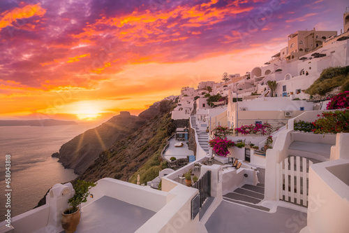 Relaxing romantic sunset view with white architecture in Santorini Greece, caldera view over blue sea and volcano island. Summer landscape for travelling and vacation template. Luxury resort hotel