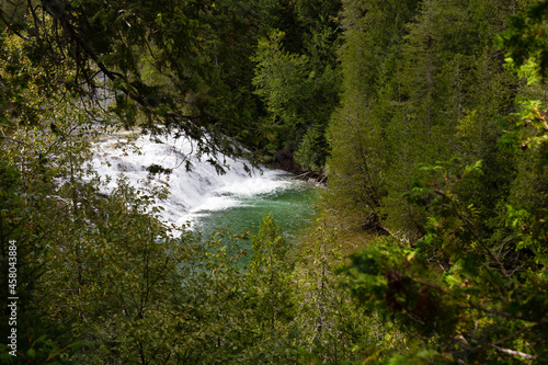 Horizontal selective focus high angle view of a fall in the so-called Emerald River seen during a beautiful late summer sunny morning  Perc    Quebec  Canada