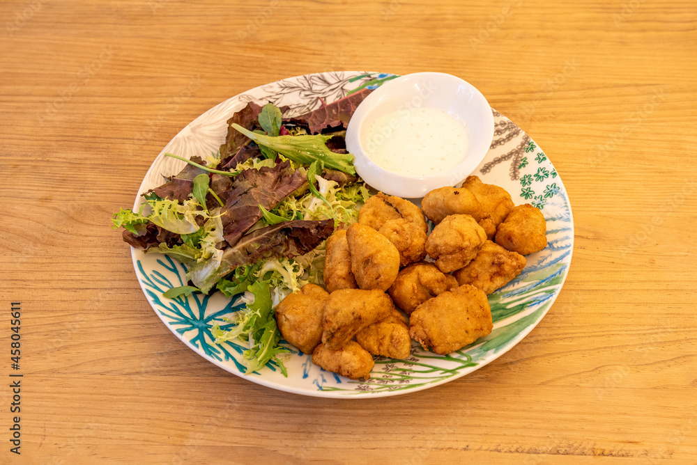 Popular Spanish recipe for marinated dogfish battered and fried in olive oil with oak lettuce and mayonnaise sauce for dipping Popular Spanish recipe for marinated dogfish battered and fried in olive oil with oak lettuce and mayonnaise sauce for dipping