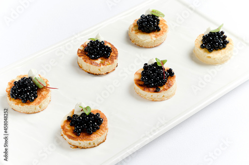 canape with black caviar and goat cheese