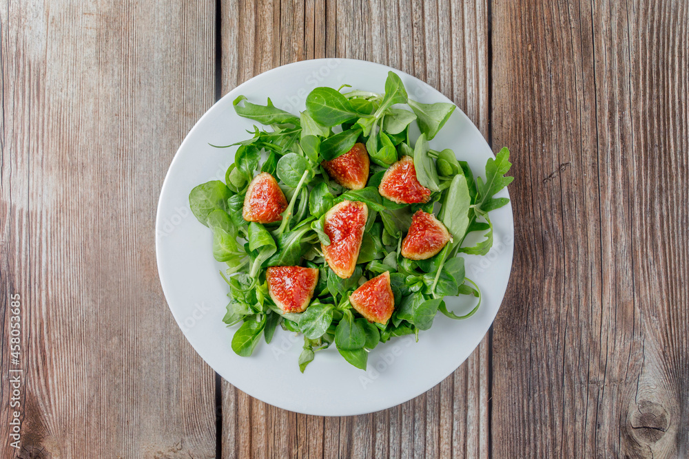 Healthy fig salad with lamb's lettuce and arugula and other vegetables. Healthy fig salad with lamb's lettuce and arugula and other vegetables.