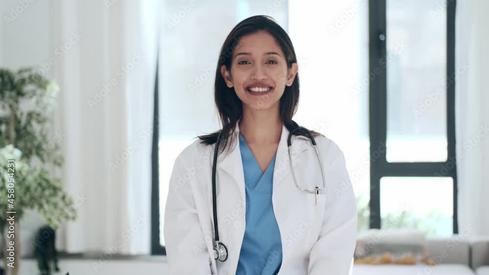 Video of happy young female doctor smiling and looking at camera while digital tablet and some documents standing in the consultation. Video of happy young female doctor smiling and looking at camera while digital tablet and some documents standing in the consultation.