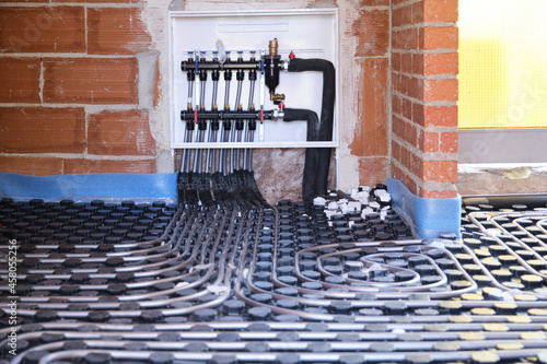 Radiant underfloor heating hydronic manifold with flexible tubing.