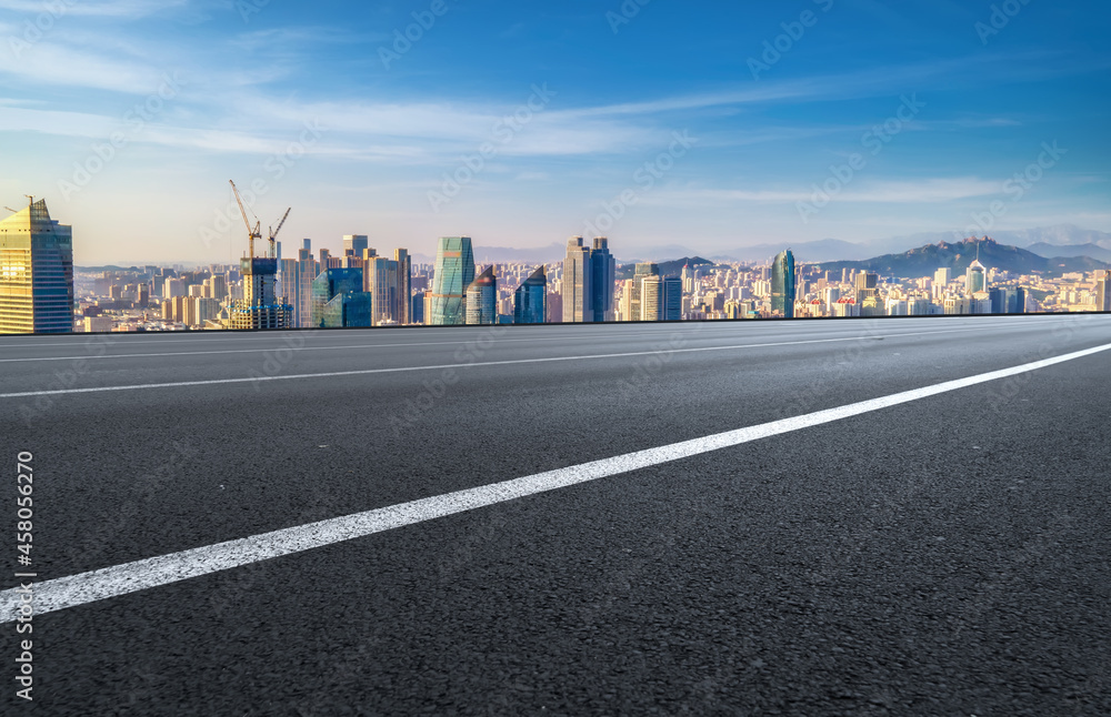 Panoramic skyline and empty asphalt road with modern buildings Panoramic skyline and empty asphalt road with modern buildings