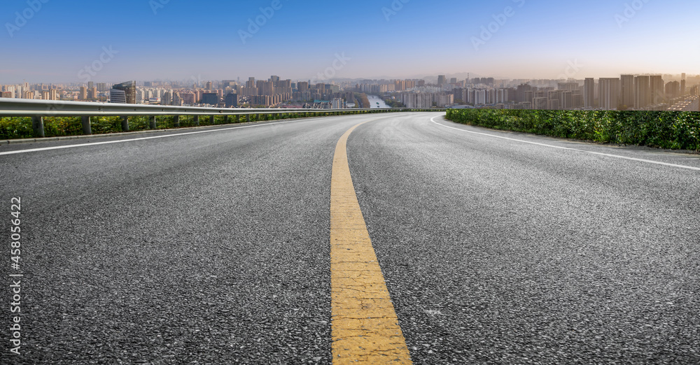 Obraz premium Panoramic skyline and empty asphalt road with modern buildings