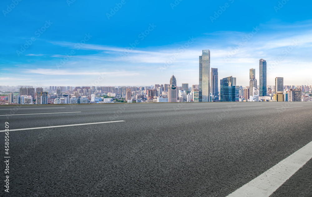Panoramic skyline and empty asphalt road with modern buildings Panoramic skyline and empty asphalt road with modern buildings