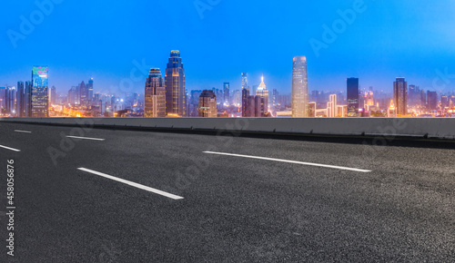 Panoramic skyline and empty asphalt road with modern buildings