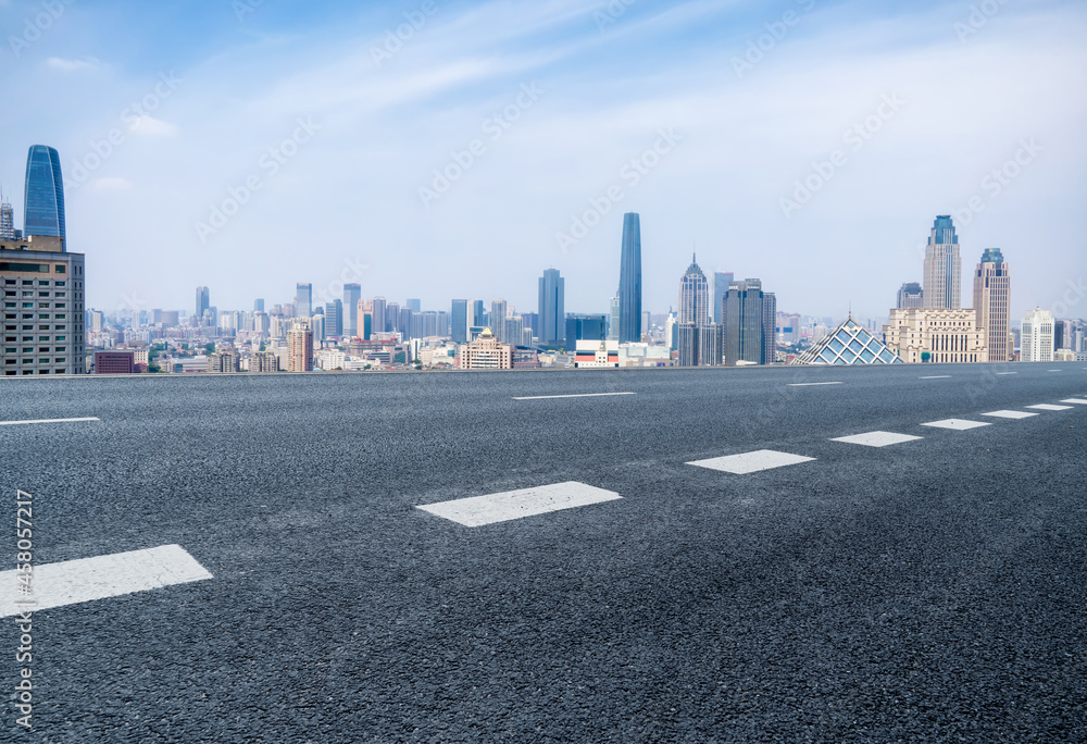 Panoramic skyline and empty asphalt road with modern buildings Panoramic skyline and empty asphalt road with modern buildings