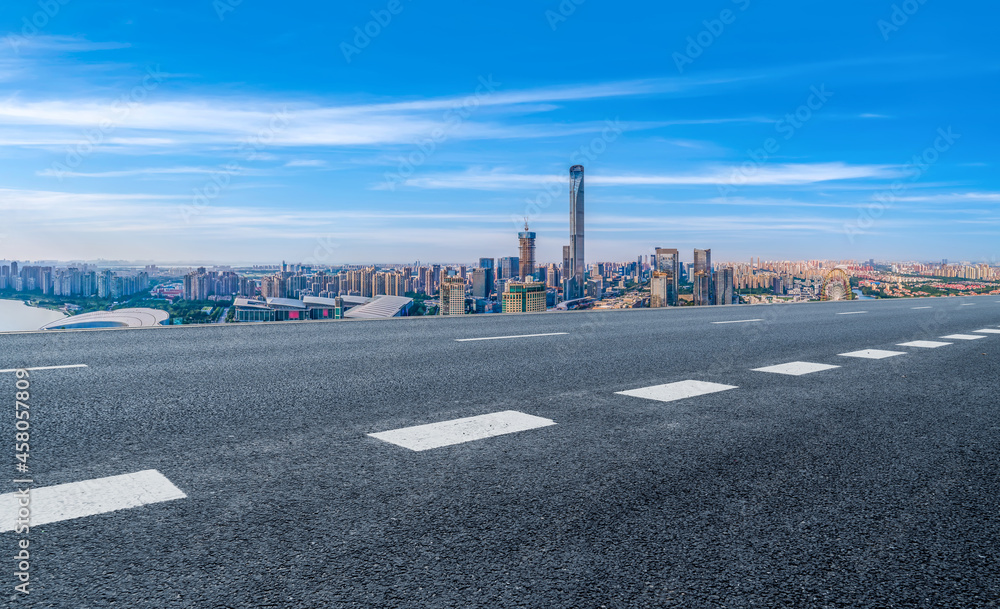 Naklejka premium Panoramic skyline and empty asphalt road with modern buildings