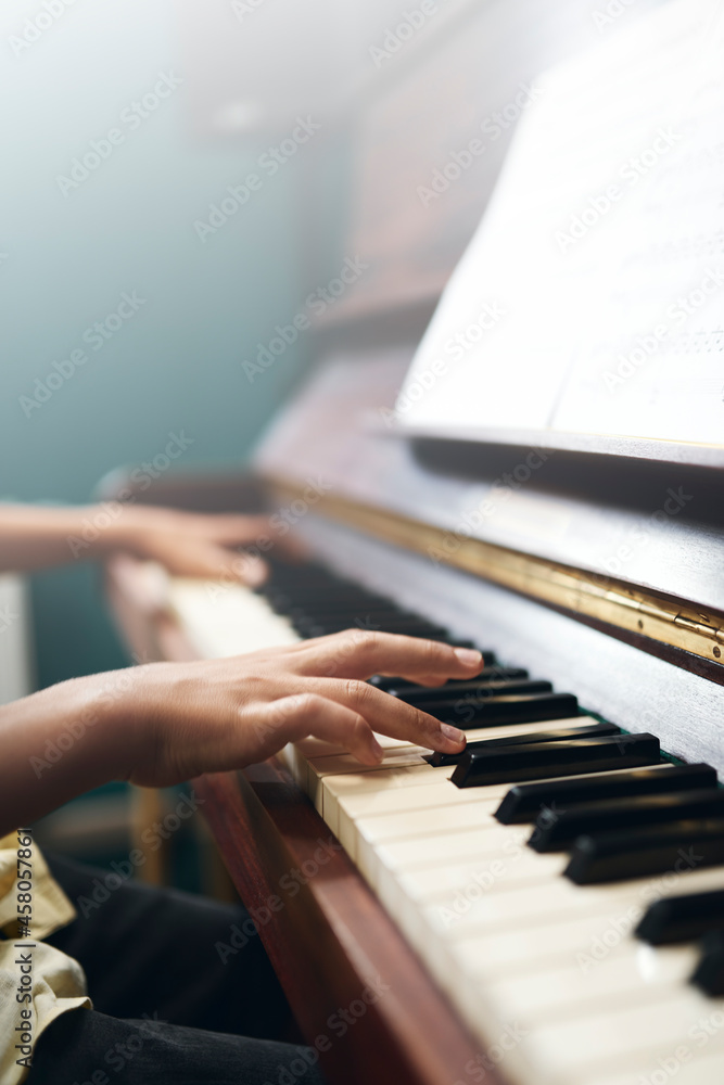 Fototapeta premium Boy's fingers on piano keyboard