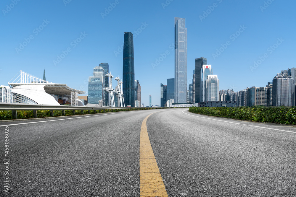 Panoramic skyline and empty asphalt road with modern buildings Panoramic skyline and empty asphalt road with modern buildings