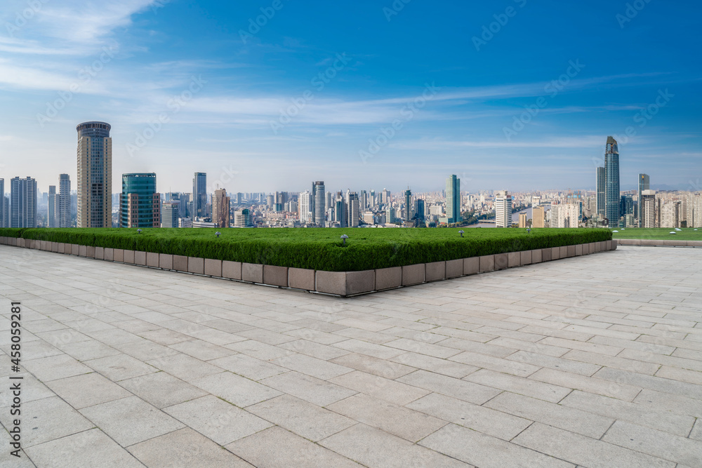 Panoramic skyline and empty square floor tiles with modern buildings Panoramic skyline and empty square floor tiles with modern buildings