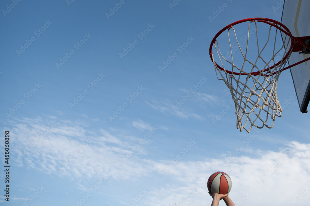 Basketball as a sports and fitness symbol of a team leisure activity playing on sky, copy space banner.
