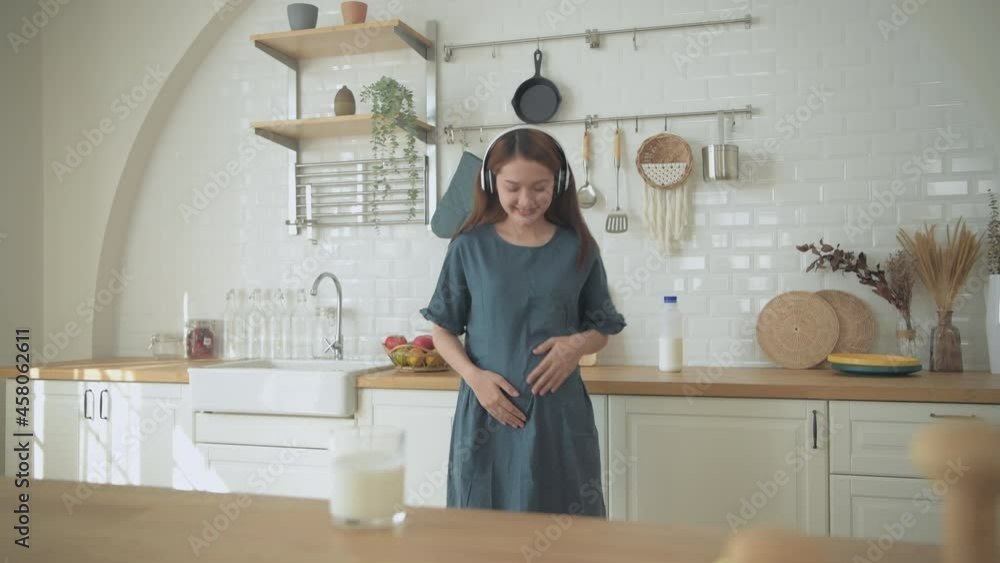 Pregnant woman concept of 4k Resolution. Asian girls are having fun dancing in the kitchen. Pregnant woman concept of 4k Resolution. Asian girls are having fun dancing in the kitchen.
