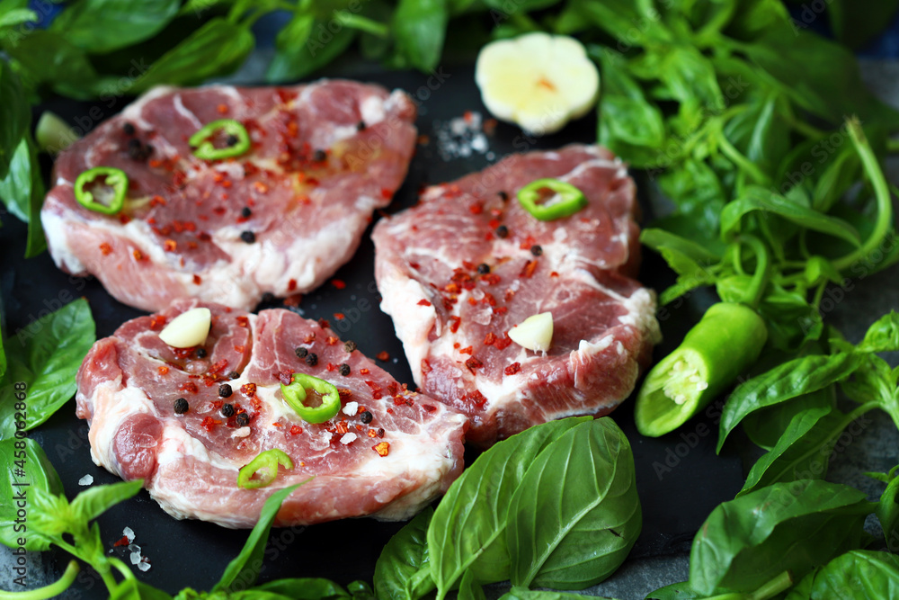 Raw steaks with basil and spices. Grill steaks.