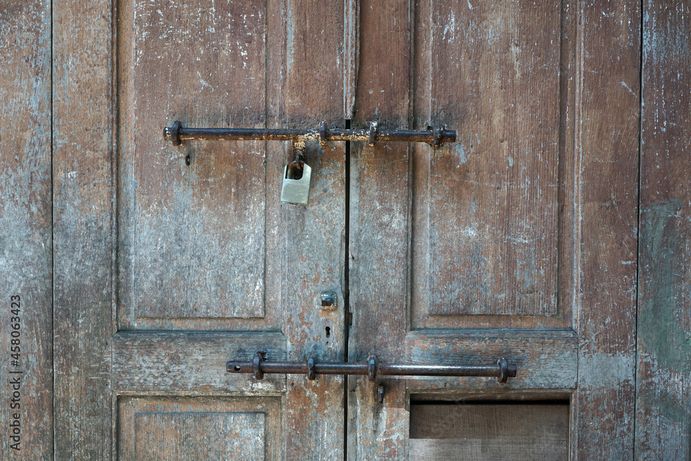 Classic old wooden door and rusty lock Classic old wooden door and rusty lock
