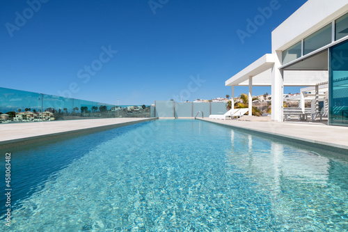 Luxurious property with an infinity swimming pool surrounded by a spacious terrace with views towards the entire coast and the ocean,  Costa Adeje, Tenerife, Canary Islands, Spain © Ana