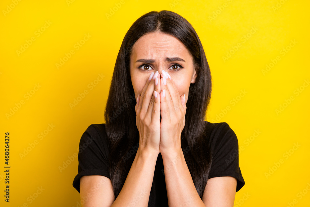 Photo of frightened troubled lady palms cover mouth wear black t-shirt isolated yellow color background Photo of frightened troubled lady palms cover mouth wear black t-shirt isolated yellow color background