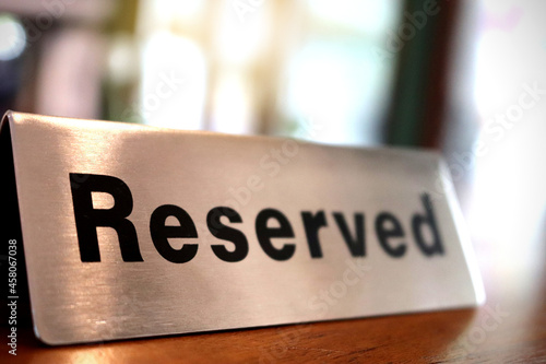Reserved sign on top of wooden table in restaurant, Reservation seat at restaurant for dating on celebrate day concept(select focus).