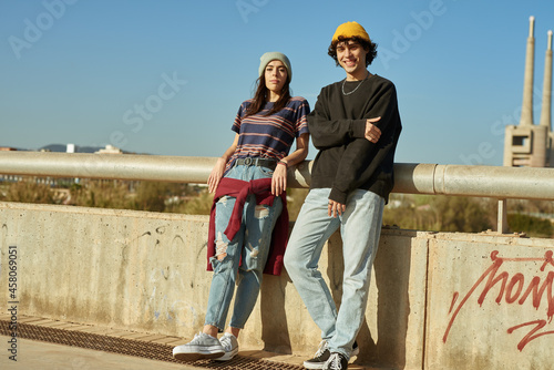 Leinwand Poster Young couple looking at you outdoors
