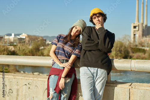 Cute girl leaning on guy outdoors