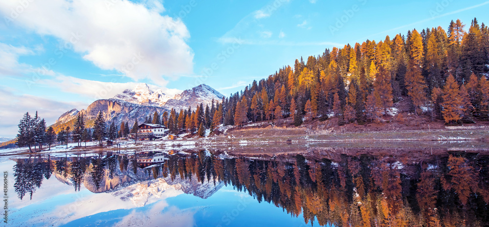 beautiful autumn landscape with yellow larch on a background of snowy mountains in the Antorno Lake, Dolomites, the Italian Alps. (Meditation, anti-stress, relaxation - concept)