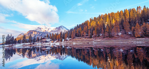 Obraz na płótnie beautiful autumn landscape with yellow larch on a background of snowy mountains in the Antorno Lake, Dolomites, the Italian Alps. (Meditation, anti-stress, relaxation - concept) w salonie