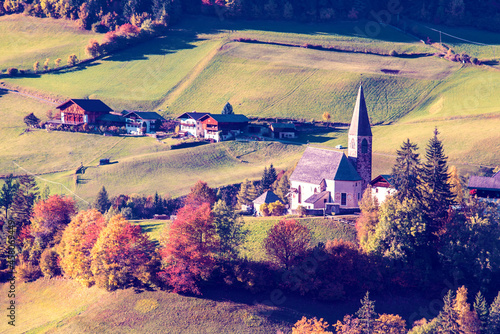 Obraz na płótnie Amazing magical autumn landscape with the church in the valley of Santa Magdalena, Italy, Europe, Dolomites. w salonie