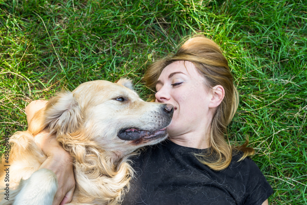 Woman plays with her dog retriever Woman plays with her dog retriever