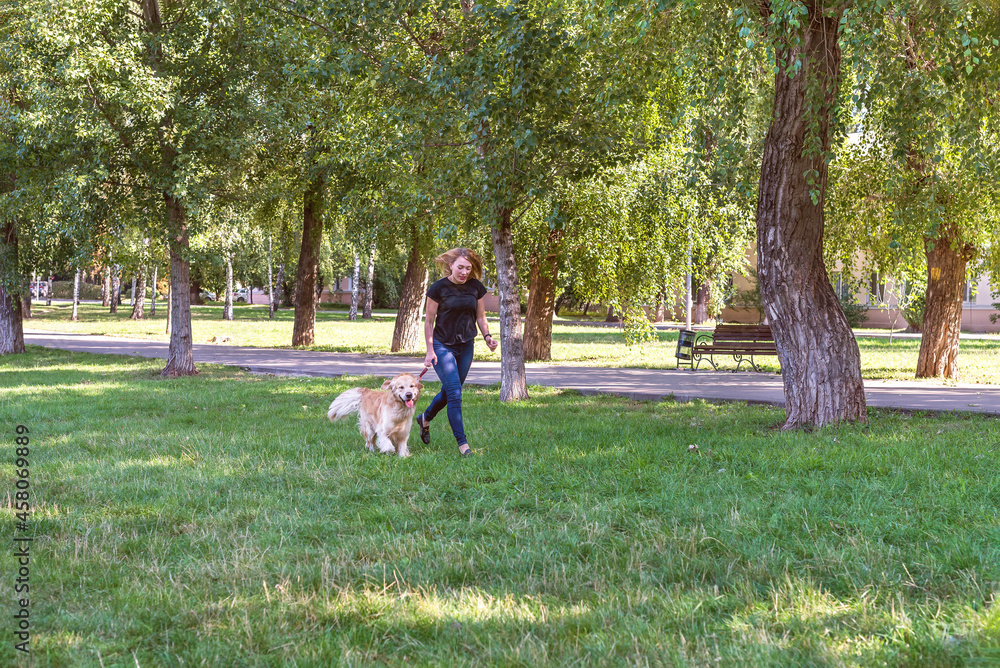 Woman with retriever dog on in the open air park. Woman with retriever dog on in the open air park.