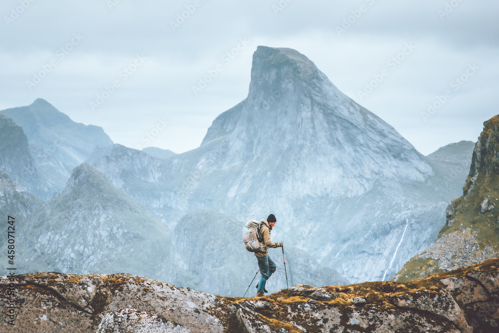 Man hiking in mountains traveling solo with backpack outdoor active vacations in Norway healthy lifestyle extreme sports - obrazy, fototapety, plakaty 