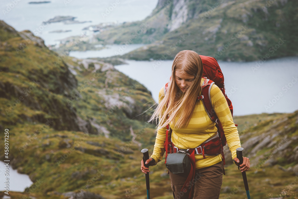 Woman hiking in Norway traveling solo with backpack outdoor active trip healthy lifestyle hobby extreme sports